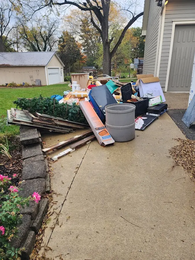 Dumpster being loaded with debris for Estate Cleanout Dumpster Rental in Casselberry